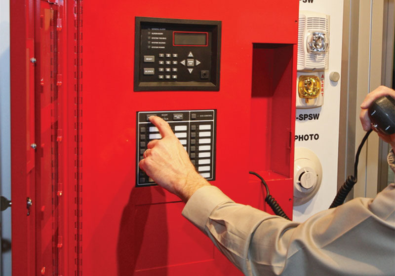 Person using emergency voice system panel.